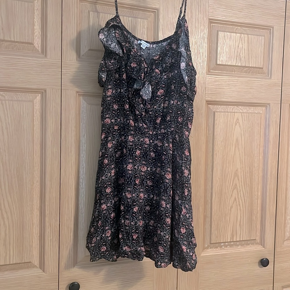 This is a short, light weight sundress. It's black with pink and white flowers.